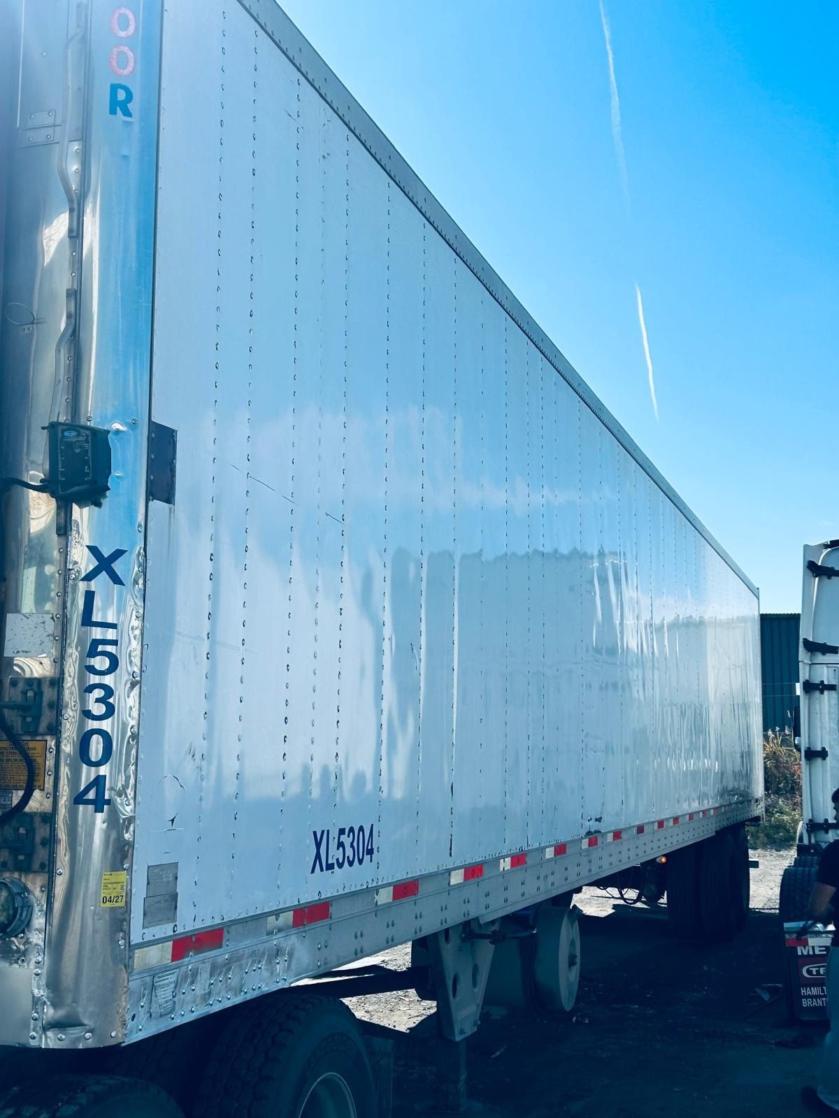 White 53-foot reefer trailer parked outdoors